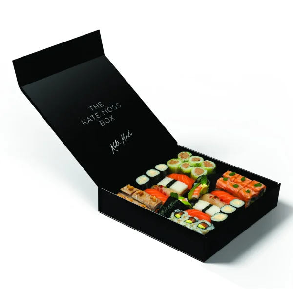 A black box containing assorted sushi and various food items arranged neatly for presentation.