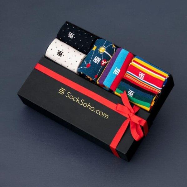 A gift box of colorful socks tied with a red ribbon and bow, ready for presentation.