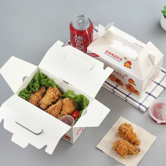 A takeout box filled with chicken wings alongside a refreshing drink.
