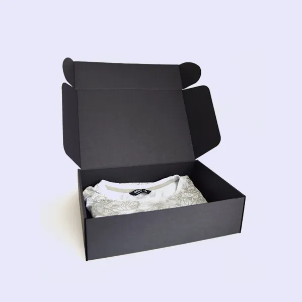 A black box containing a neatly folded white shirt inside.