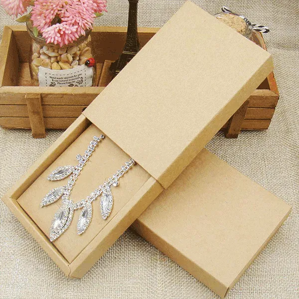 A pendant box containing a delicate necklace and a vibrant flower, elegantly arranged inside.